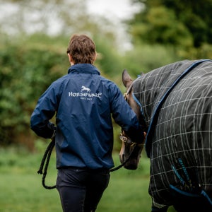 Trainer leading a horse with precision 