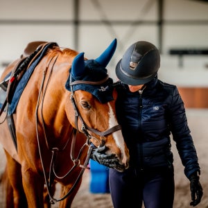 Trainer comforts horse