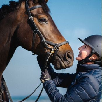 woman looking at horse