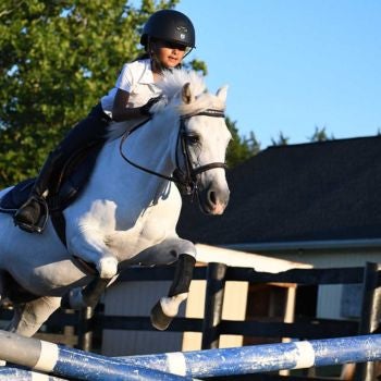 girl jumping pony